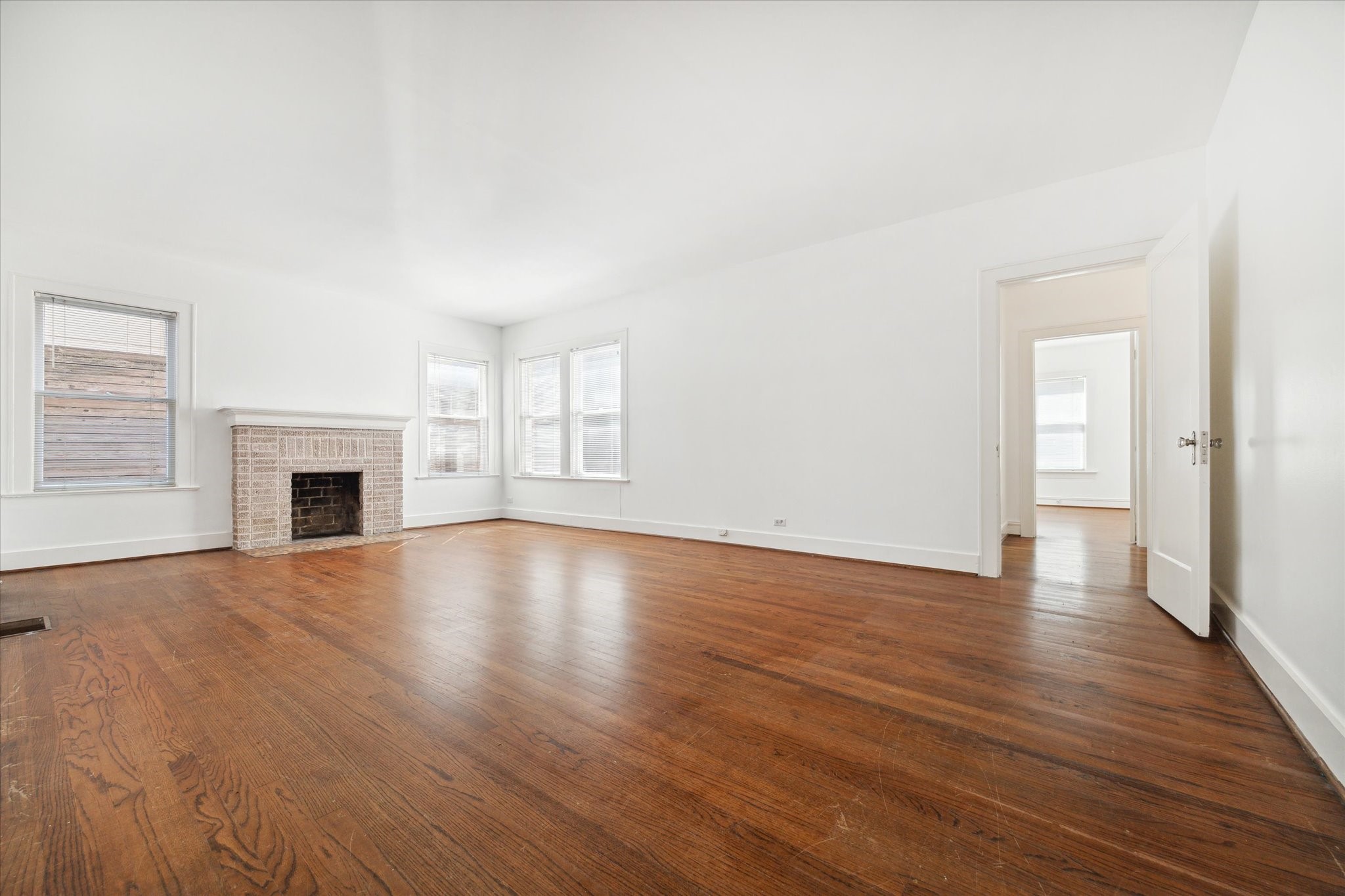 2309 Wroxton Road Houston, TX 77005 - Photo 4 of 15 an empty room with wooden floor and fireplace
