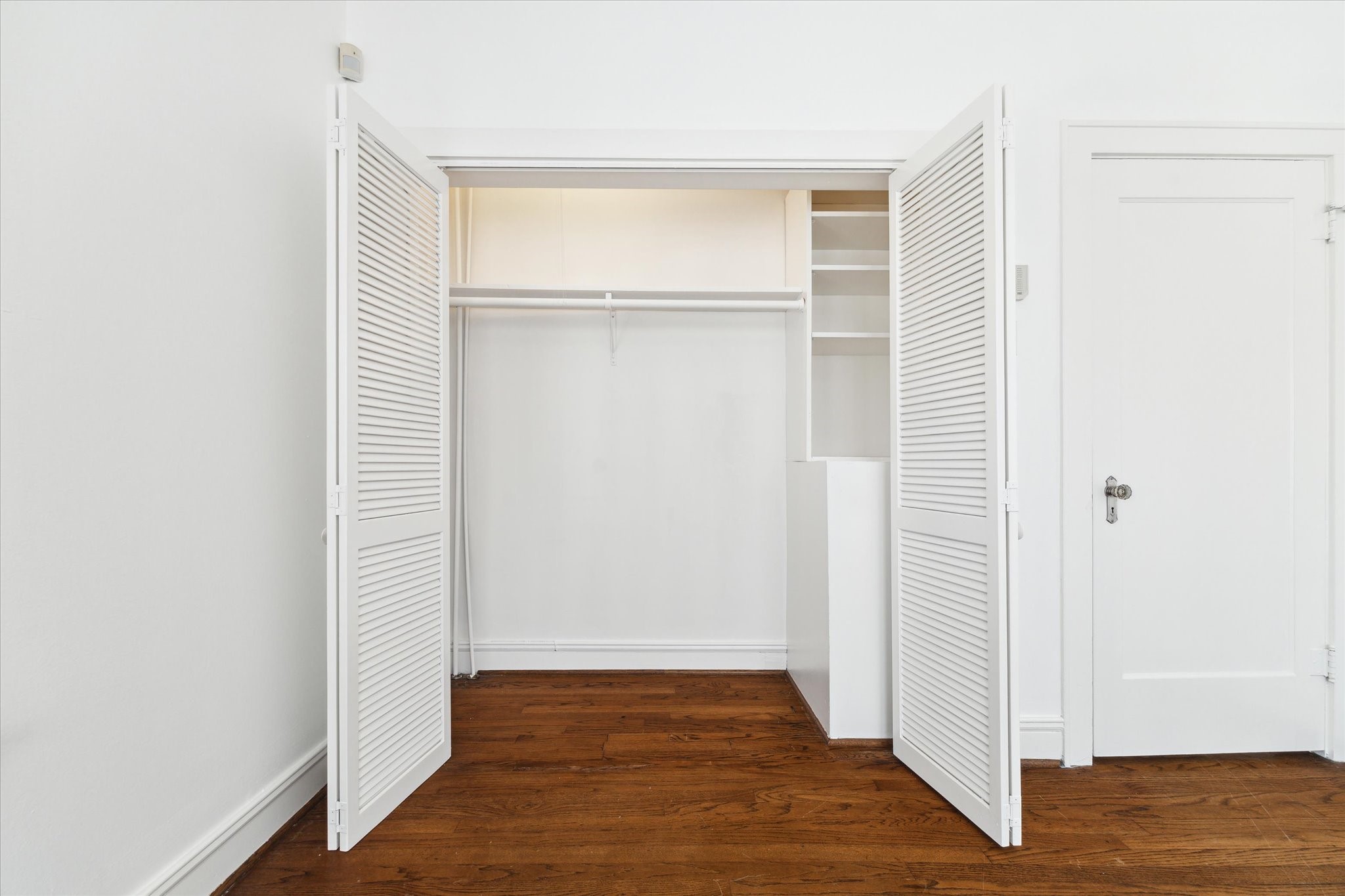 2309 Wroxton Road Houston, TX 77005 - Photo 6 of 15 a view of an empty room with wooden floor and a window