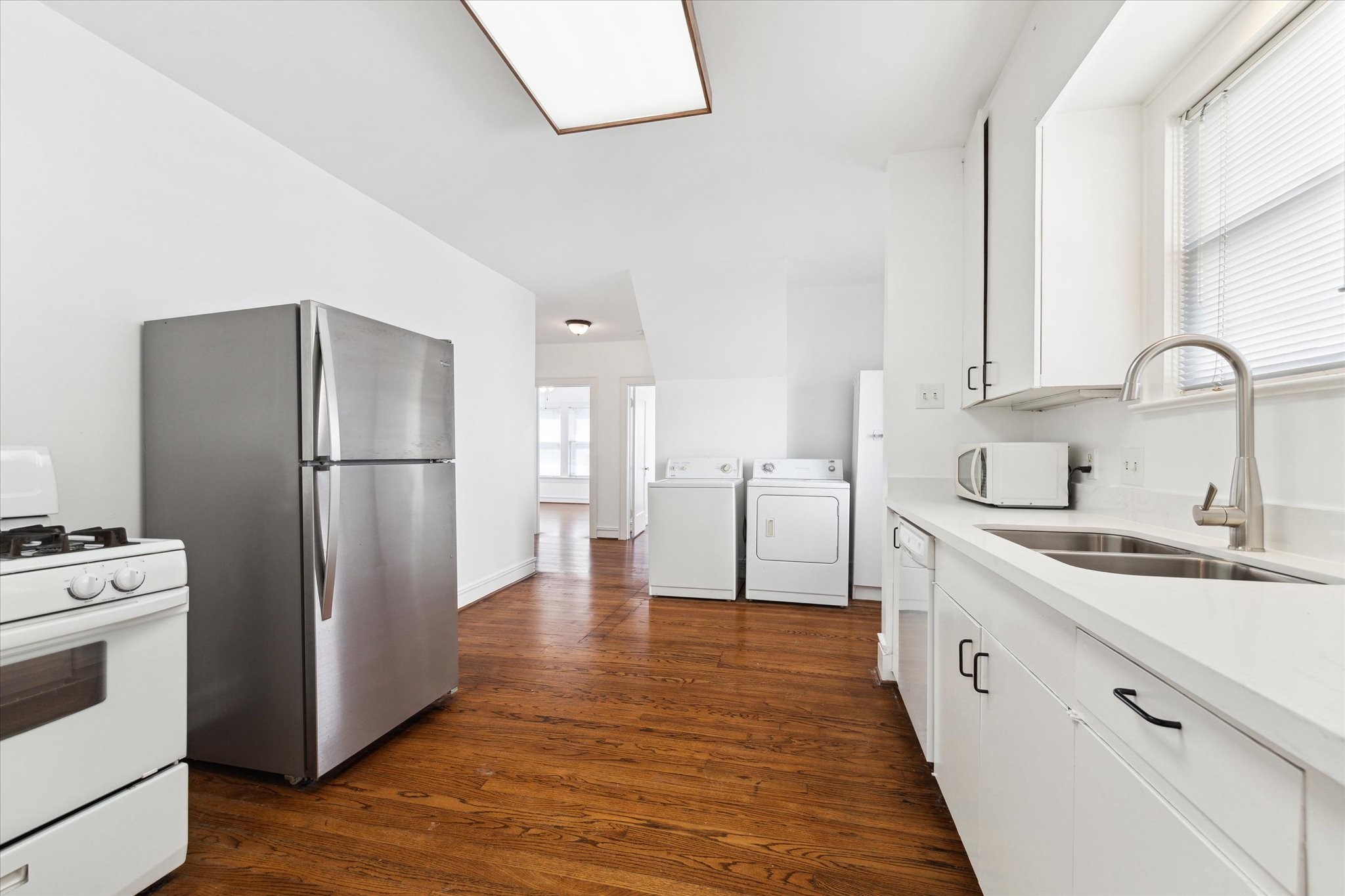 2309 Wroxton Road Houston, TX 77005 - Photo 9 of 15 a kitchen with stainless steel appliances a refrigerator sink and cabinets