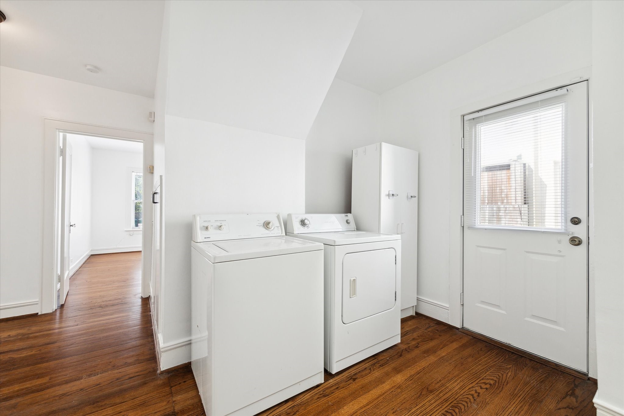 2309 Wroxton Road Houston, TX 77005 - Photo 10 of 15 a utility room with cabinets washer and dryer