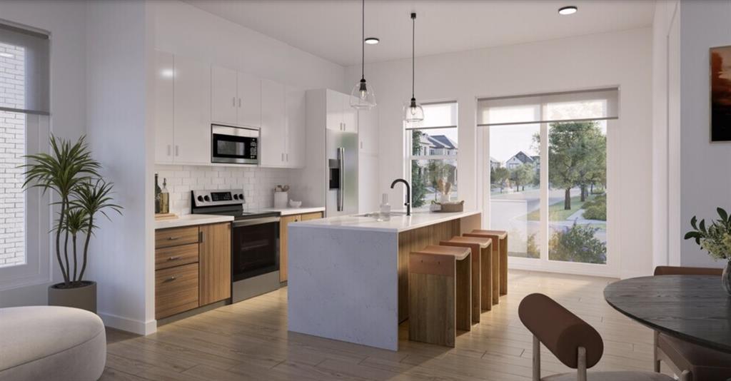 3591 Oxenfree Boulevard, Unit 3537 Frisco, TX 75035 - Photo 3 of 17 a kitchen with kitchen island a counter top a stove a sink a dining table and chairs