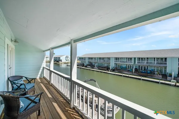 a view of a balcony with chairs