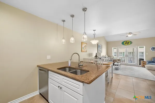 a kitchen with a sink cabinets and window