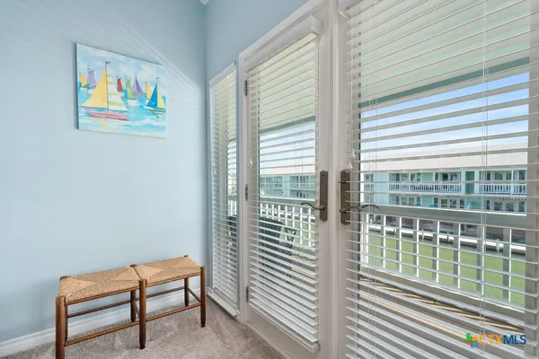 a view of a balcony with wooden floor and furniture