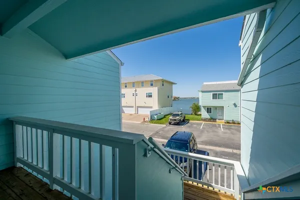 a balcony view with chairs and wooden floor