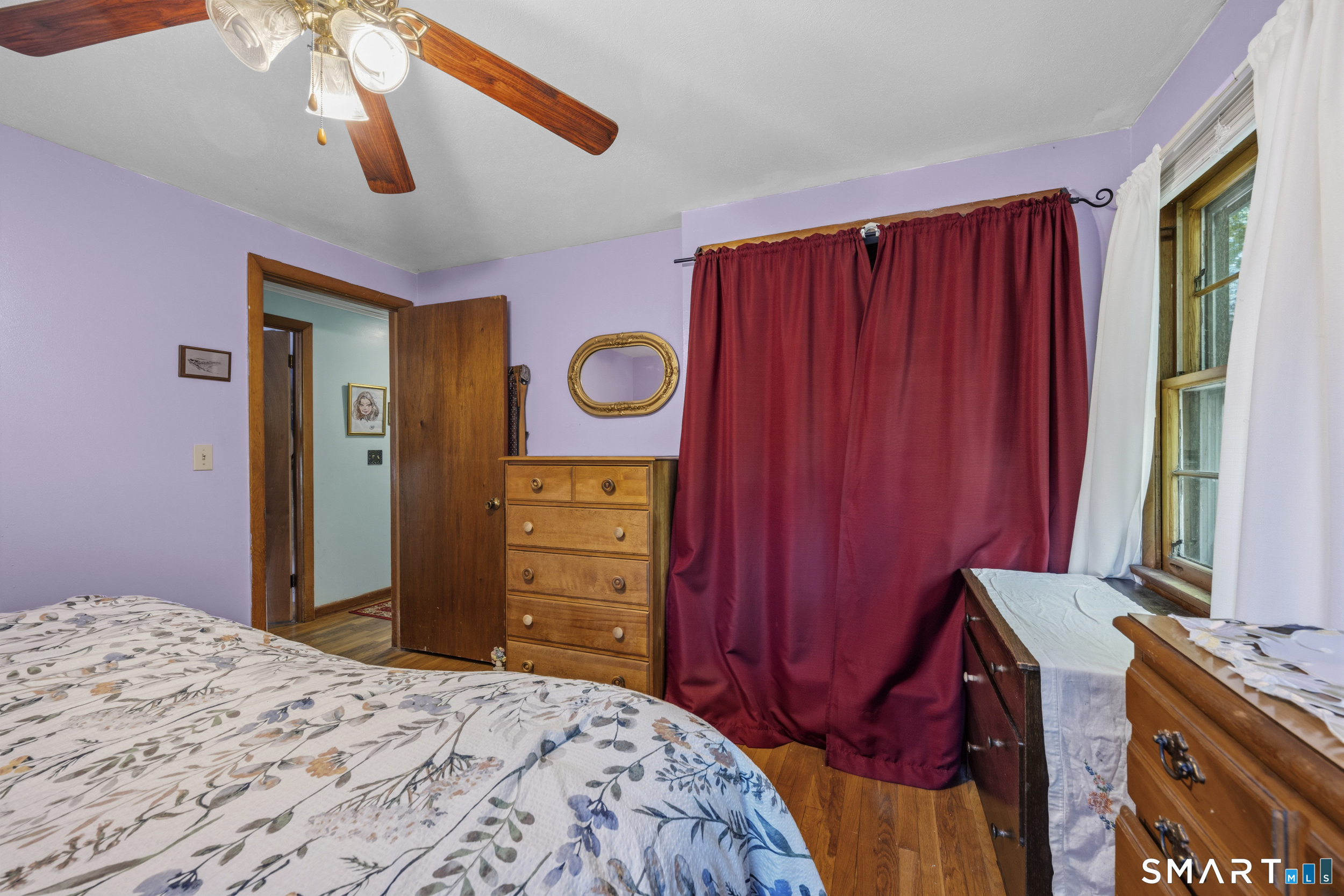 121 River Road Preston, CT 06365 - Photo 21 of 37 a bedroom with a bed and a chandelier