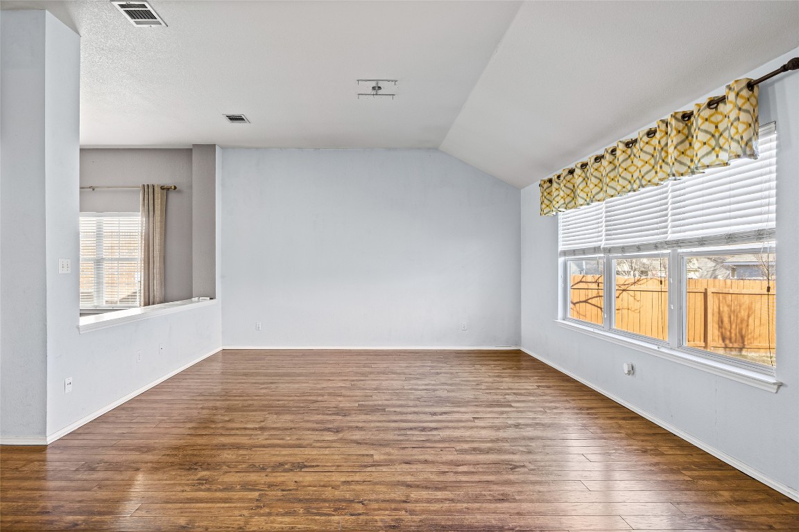 1321 Bunratty Circle Pflugerville, TX 78660 - Photo 13 of 31 Unfurnished room featuring dark wood finished floors and lofted ceiling