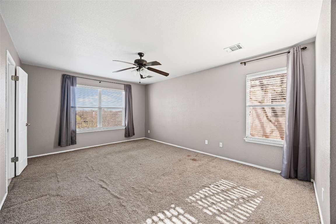 1321 Bunratty Circle Pflugerville, TX 78660 - Photo 20 of 31 Carpeted spare room featuring a ceiling fan and baseboards