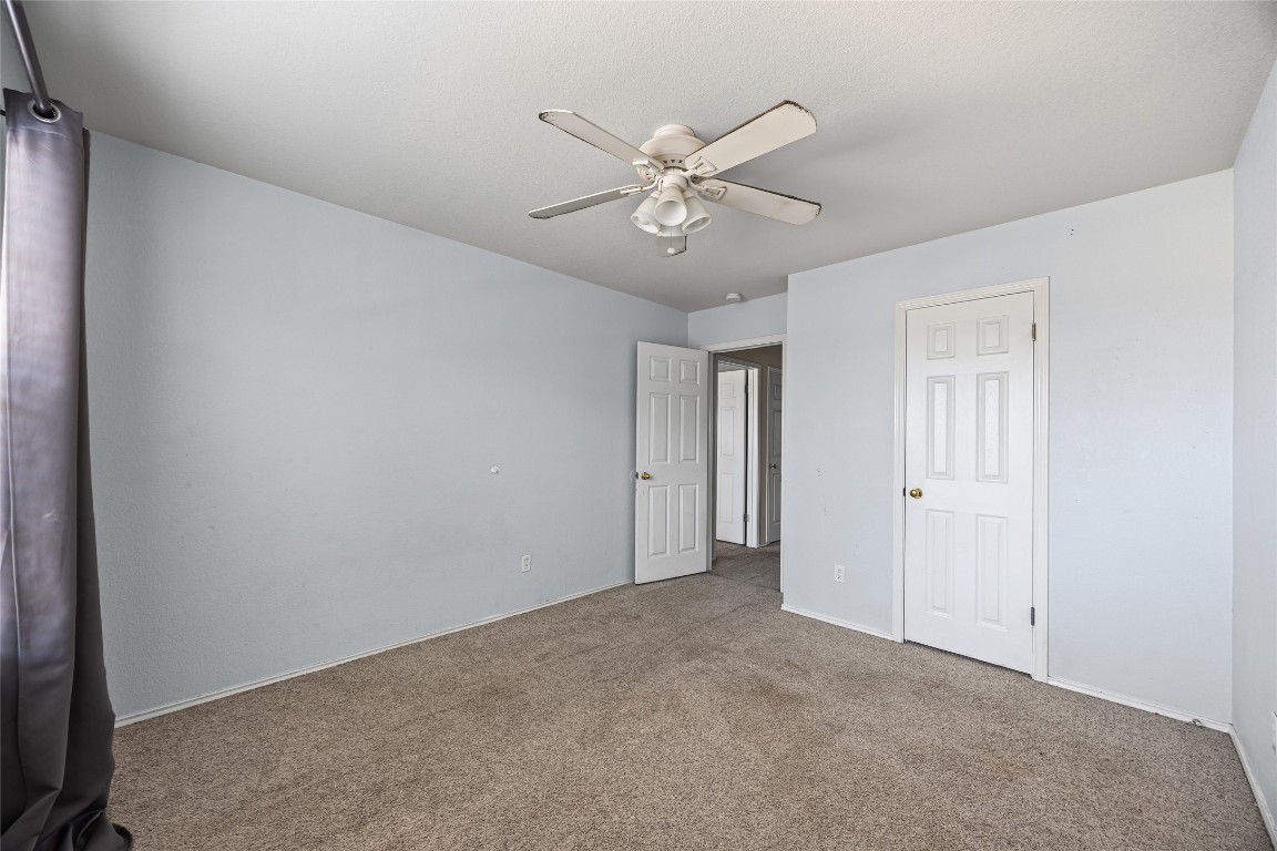 1321 Bunratty Circle Pflugerville, TX 78660 - Photo 26 of 31 Unfurnished bedroom featuring ceiling fan and carpet