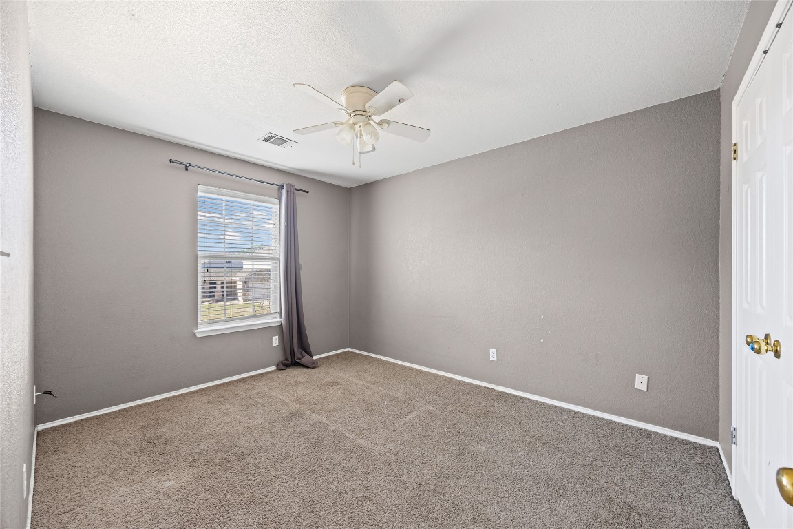 1321 Bunratty Circle Pflugerville, TX 78660 - Photo 27 of 31 Carpeted spare room featuring baseboards and ceiling fan