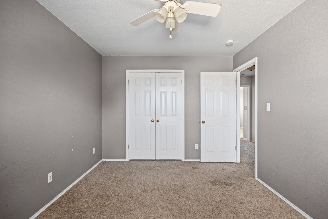1321 Bunratty Circle Pflugerville, TX 78660 - Photo 28 of 31 Unfurnished bedroom with ceiling fan, a closet, and carpet