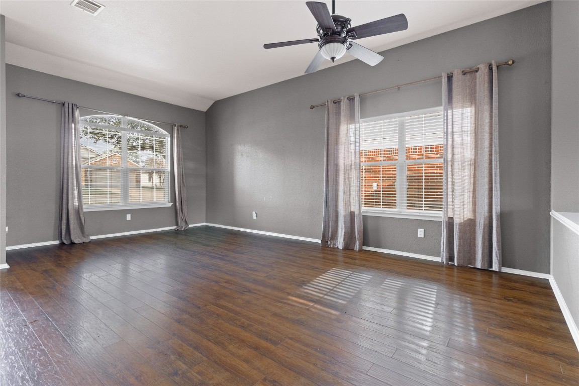 1321 Bunratty Circle Pflugerville, TX 78660 - Photo 29 of 31 Spare room with dark wood-style floors, a ceiling fan, and vaulted ceiling