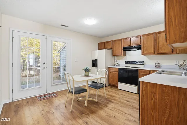 a kitchen with a sink a counter top space and appliances