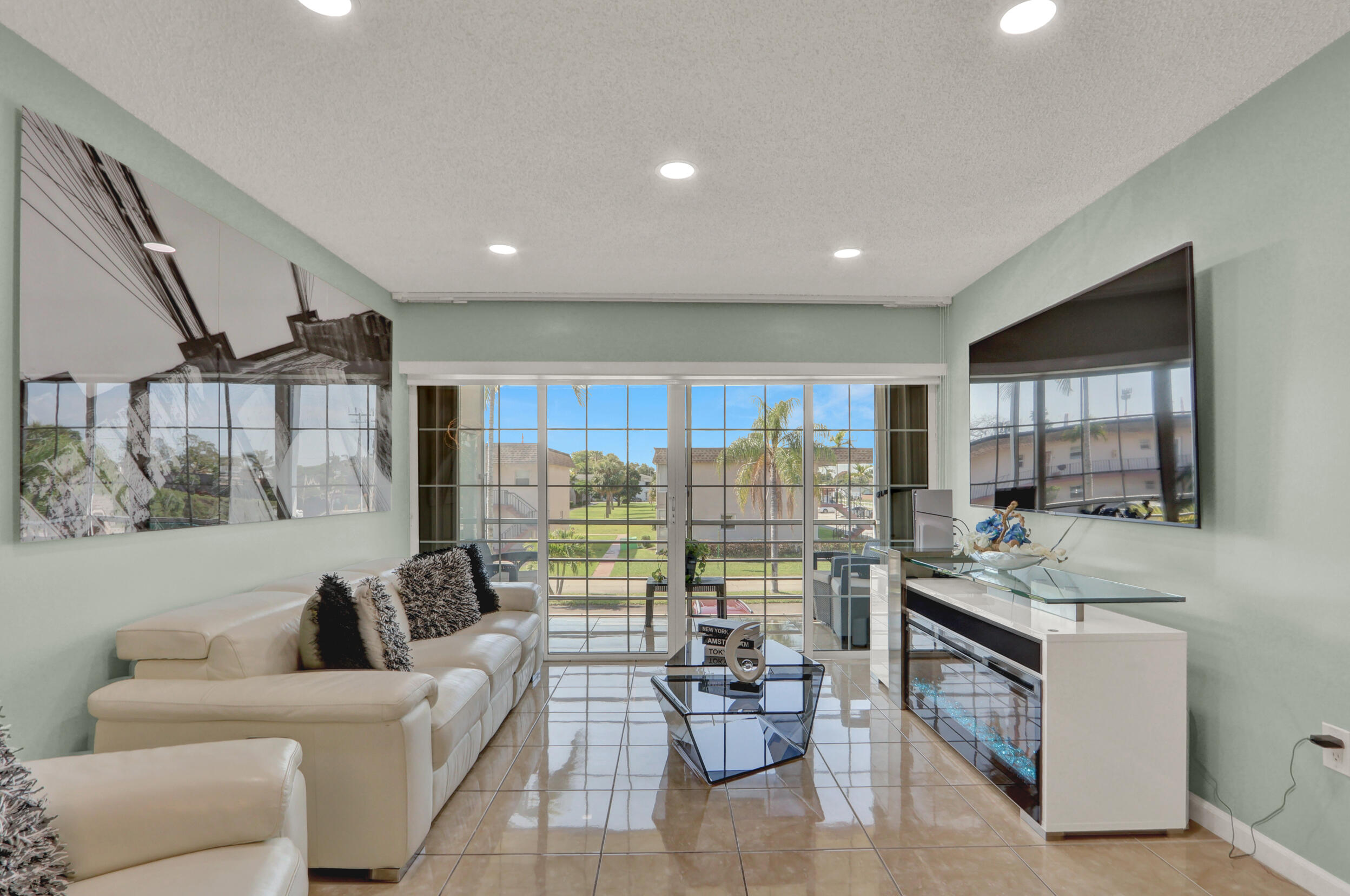 502 Davis Road, Unit 12 Palm Springs, FL 33461 - Photo 1 of 23 a living room with furniture and a large window