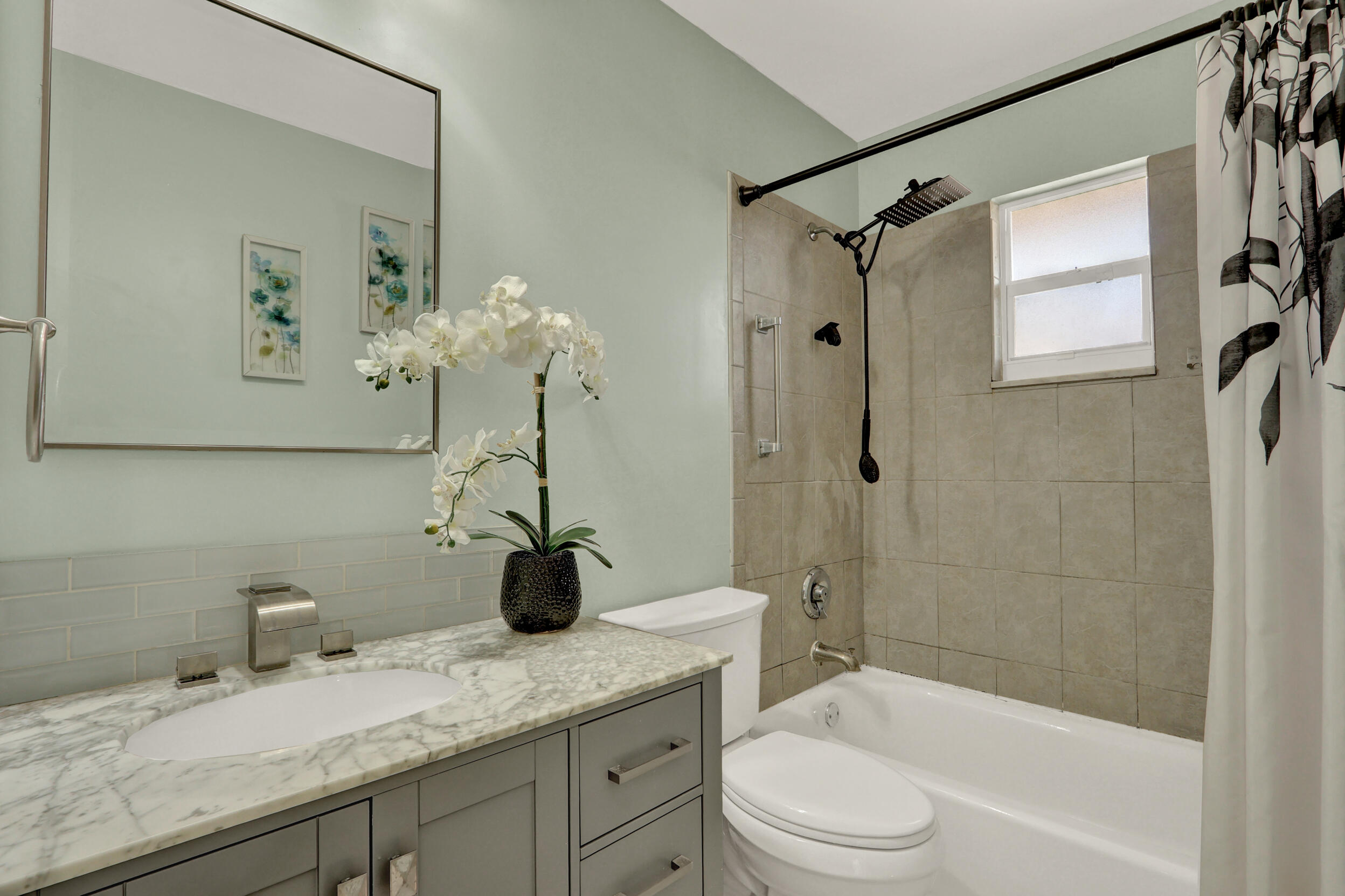 502 Davis Road, Unit 12 Palm Springs, FL 33461 - Photo 15 of 23 a bathroom with a granite countertop sink a toilet and shower