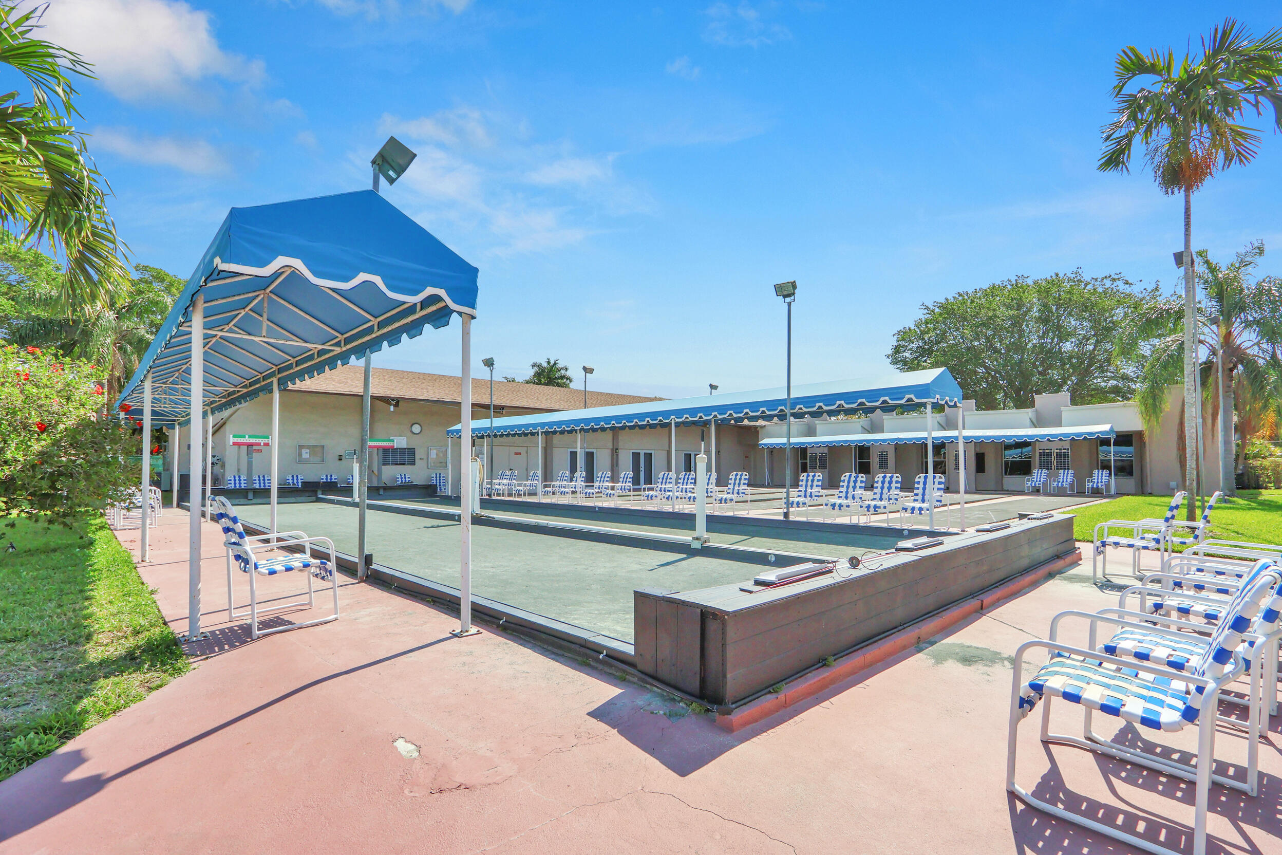 502 Davis Road, Unit 12 Palm Springs, FL 33461 - Photo 20 of 23 a view of a swimming pool with a patio