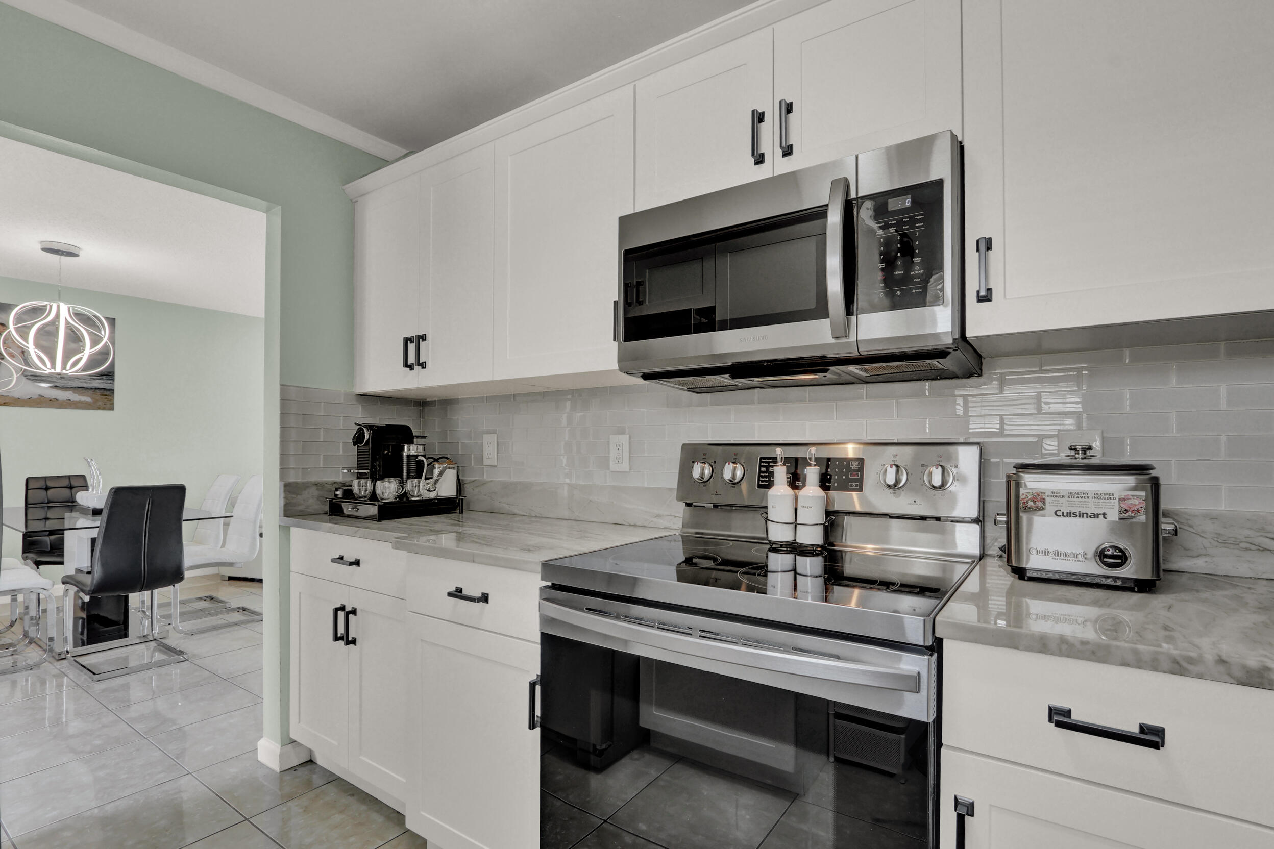 502 Davis Road, Unit 12 Palm Springs, FL 33461 - Photo 10 of 23 a kitchen with stainless steel appliances granite countertop a sink and a stove