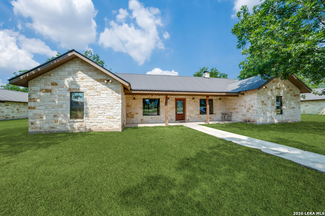 170 Johhny Seibert Lane Rio Frio, TX 78879 - Photo 4 of 50 a view of a yard in front of a house with plants and large tree