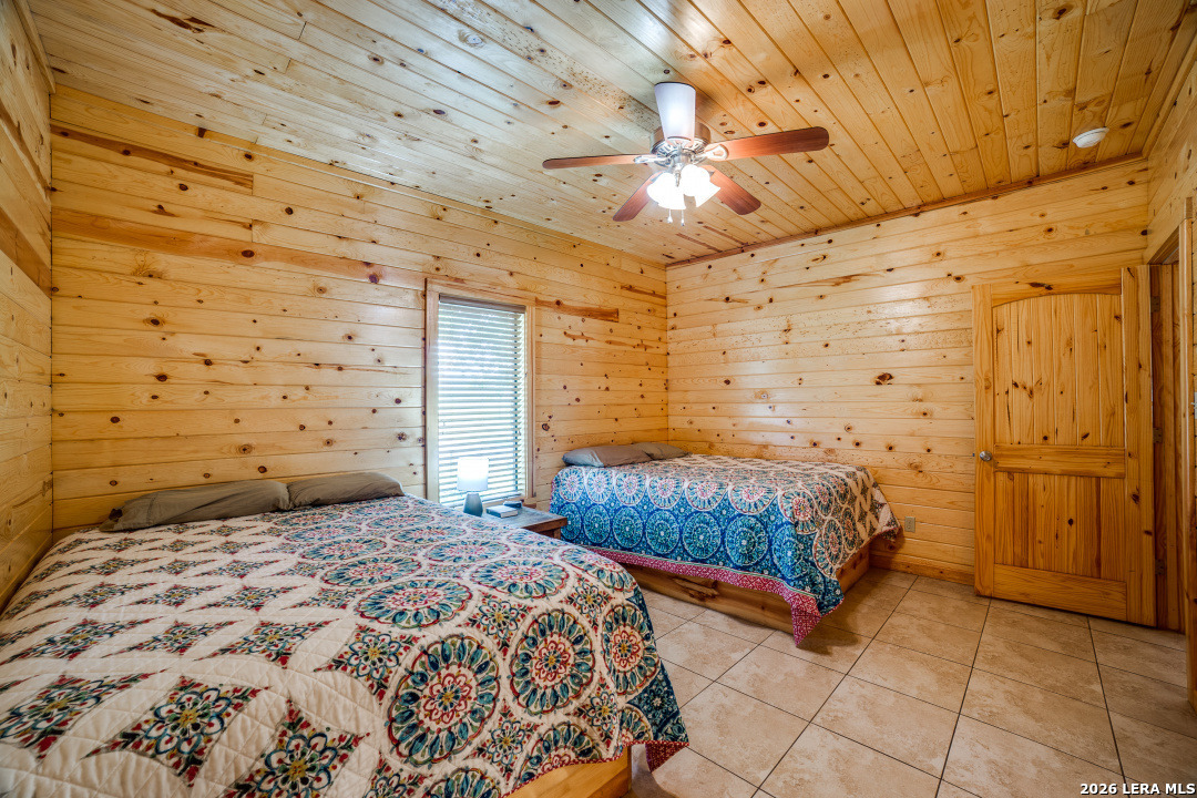170 Johhny Seibert Lane Rio Frio, TX 78879 - Photo 8 of 50 a bedroom with a bed and a chandelier