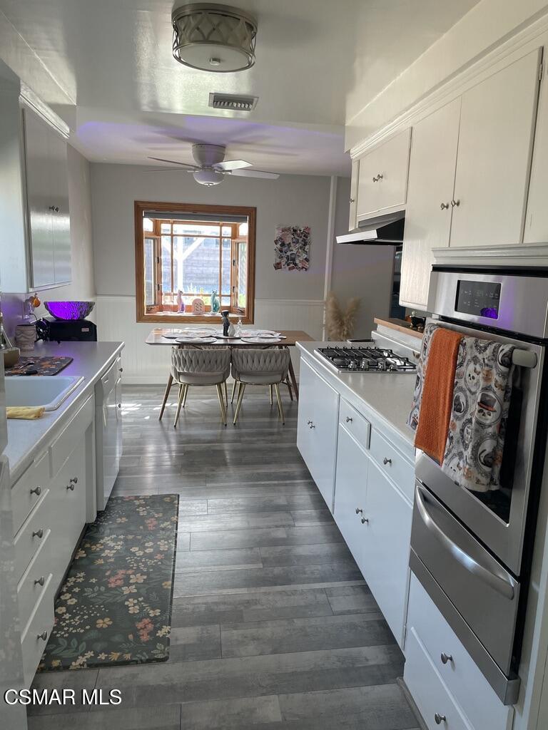 4139 Cochran Street Simi Valley, CA 93063 - Photo 3 of 21 a kitchen with stainless steel appliances granite countertop a stove top oven a sink dishwasher and cabinets with wooden floor