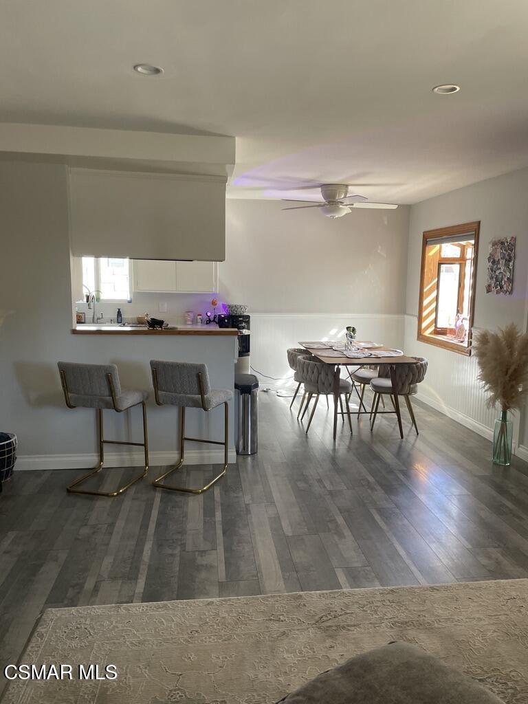 4139 Cochran Street Simi Valley, CA 93063 - Photo 7 of 21 a dining room with furniture a rug and wooden floor