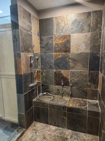 a bathroom with a shower and a sink