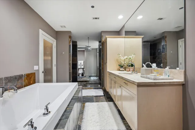 a large bathroom with a double vanity sink and a mirror
