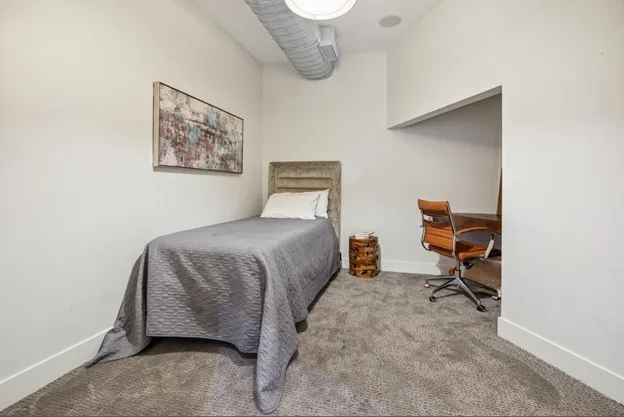 a bedroom with a bed and chair