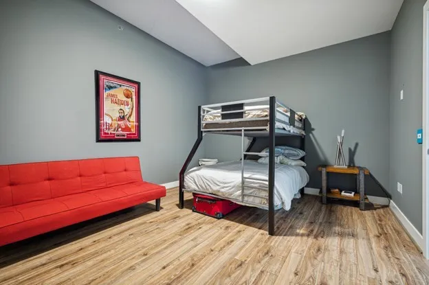 a bedroom with a bed and a view of kitchen