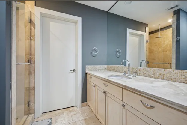 a bathroom with a granite countertop sink and a mirror