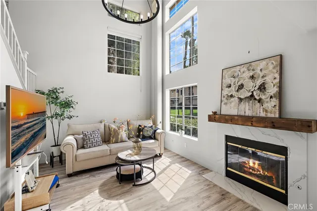 a living room with furniture a fireplace and a flat screen tv