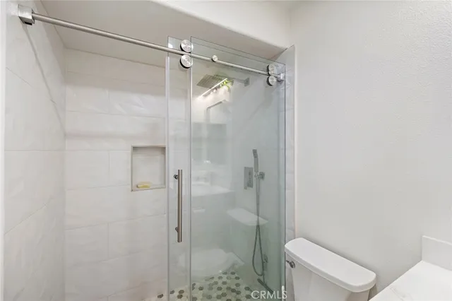 a bathroom with a shower and a toilet