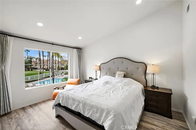 a bedroom with a bed and a large window