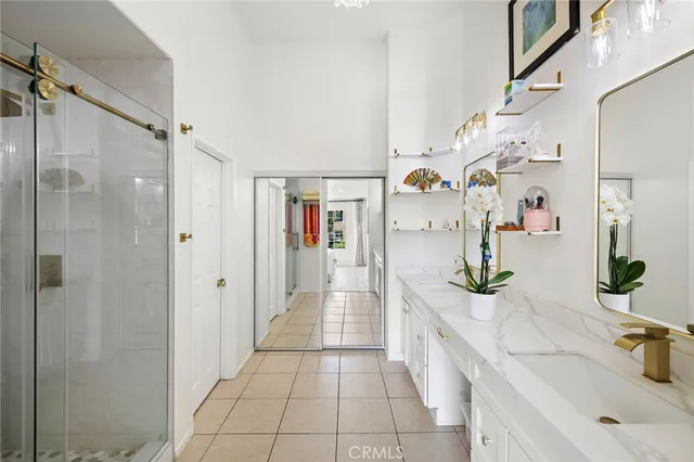 a spacious bathroom with a granite countertop shower a sink and a mirror