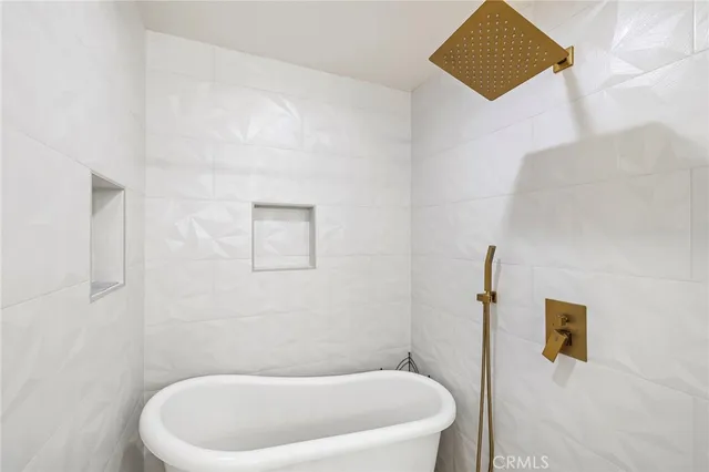 a white bath tub sitting in a bathroom