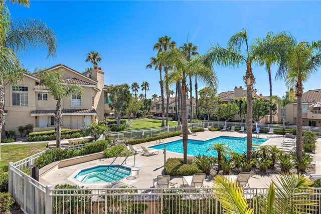 a view of a house with swimming pool and sitting area