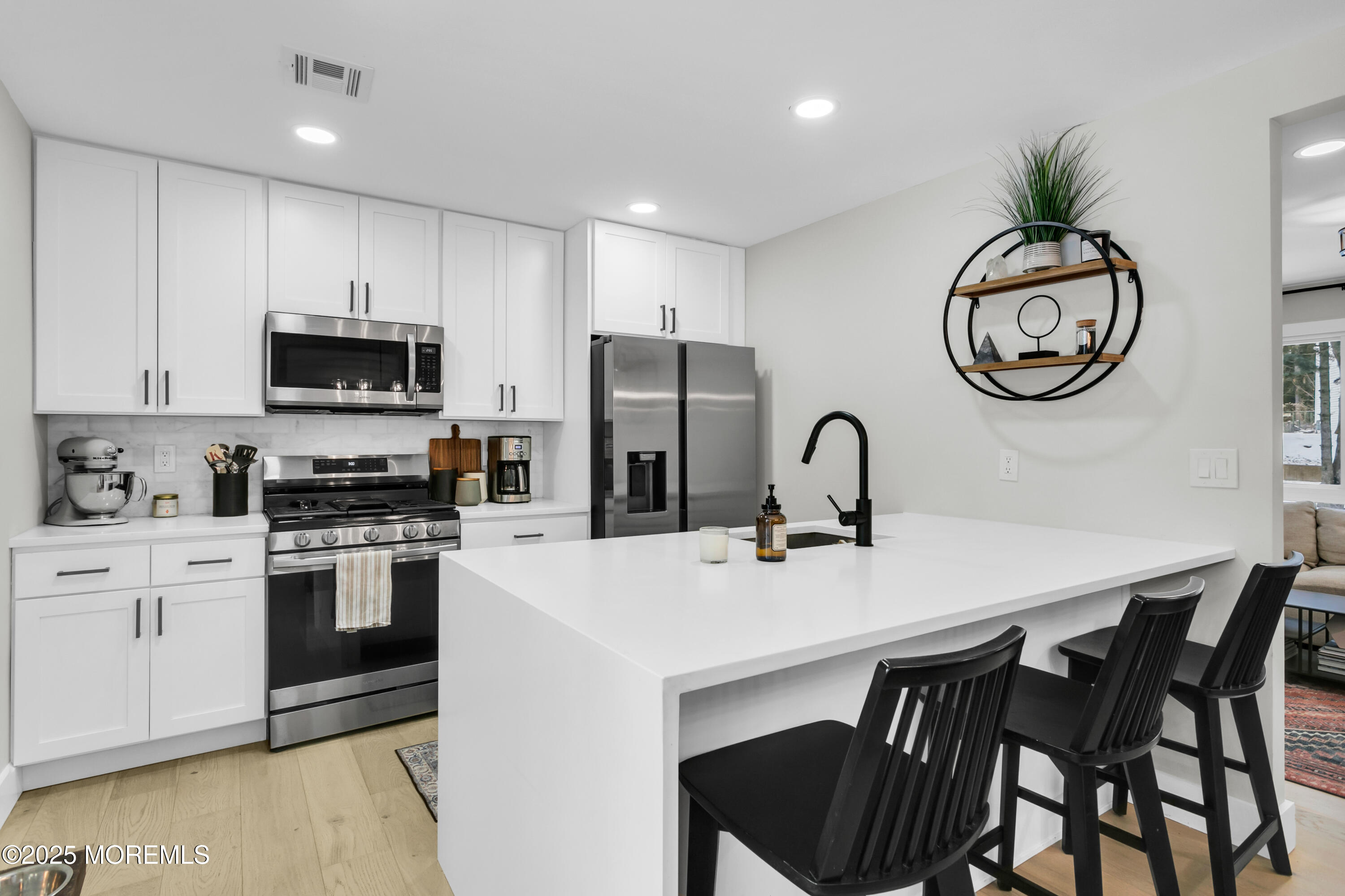 197 Oak Hill Road Red Bank, NJ 07701 - Photo 12 of 26 a kitchen with stainless steel appliances granite countertop a stove a sink dishwasher a microwave oven with a dining table and chairs