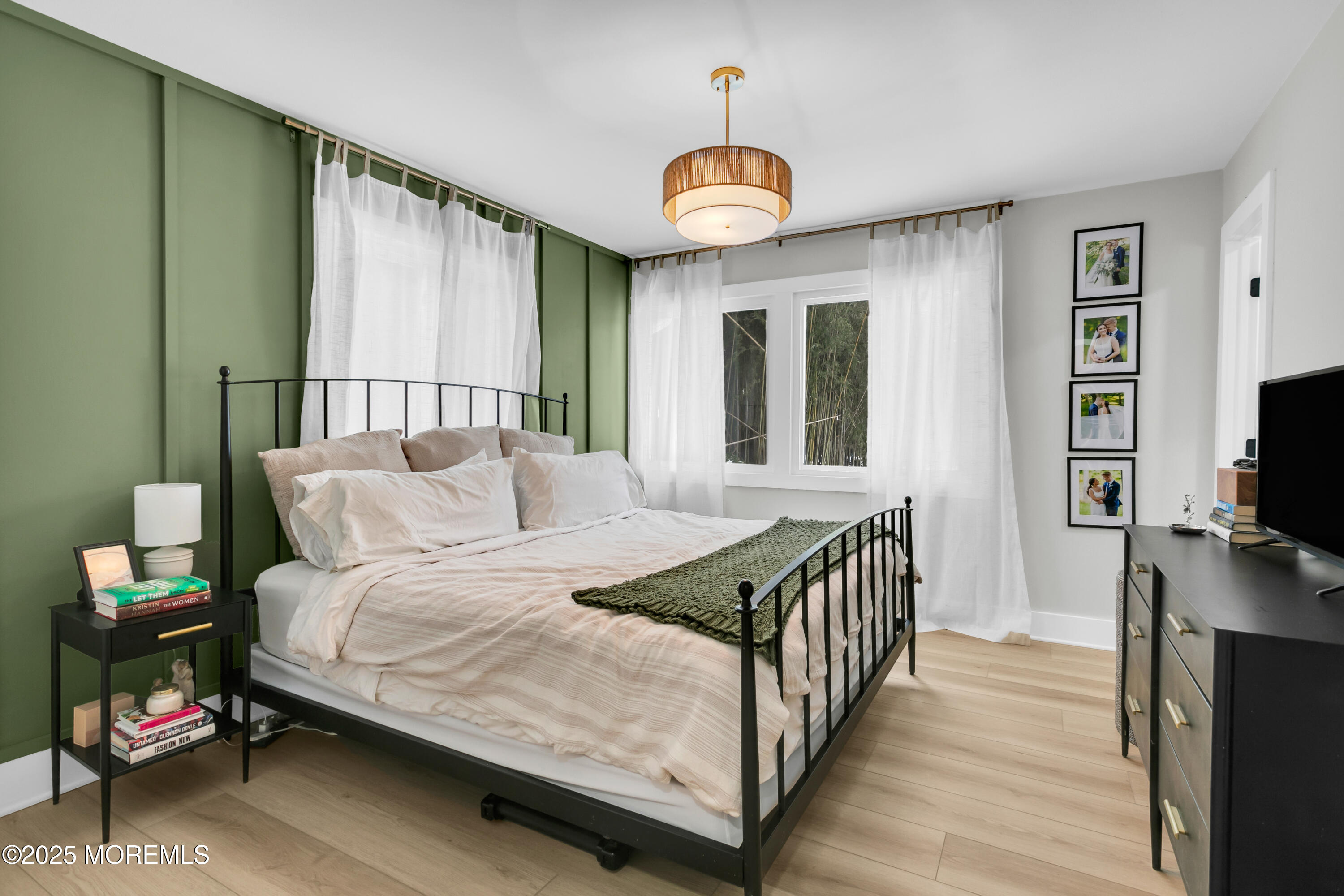 197 Oak Hill Road Red Bank, NJ 07701 - Photo 19 of 26 a bedroom with a bed and a chandelier