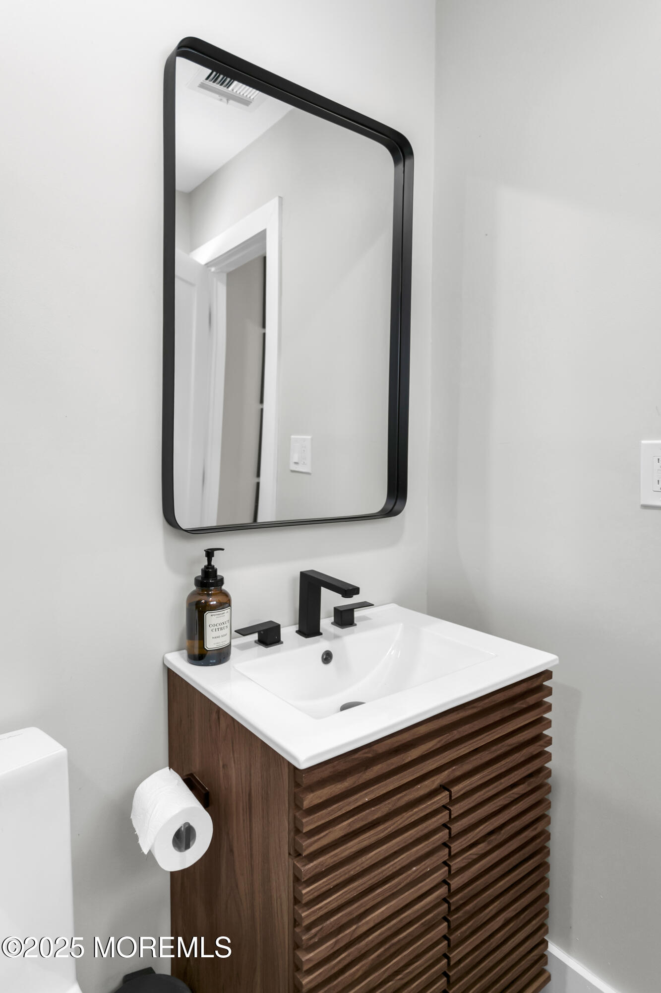 197 Oak Hill Road Red Bank, NJ 07701 - Photo 22 of 26 a bathroom with a sink a toilet and mirror