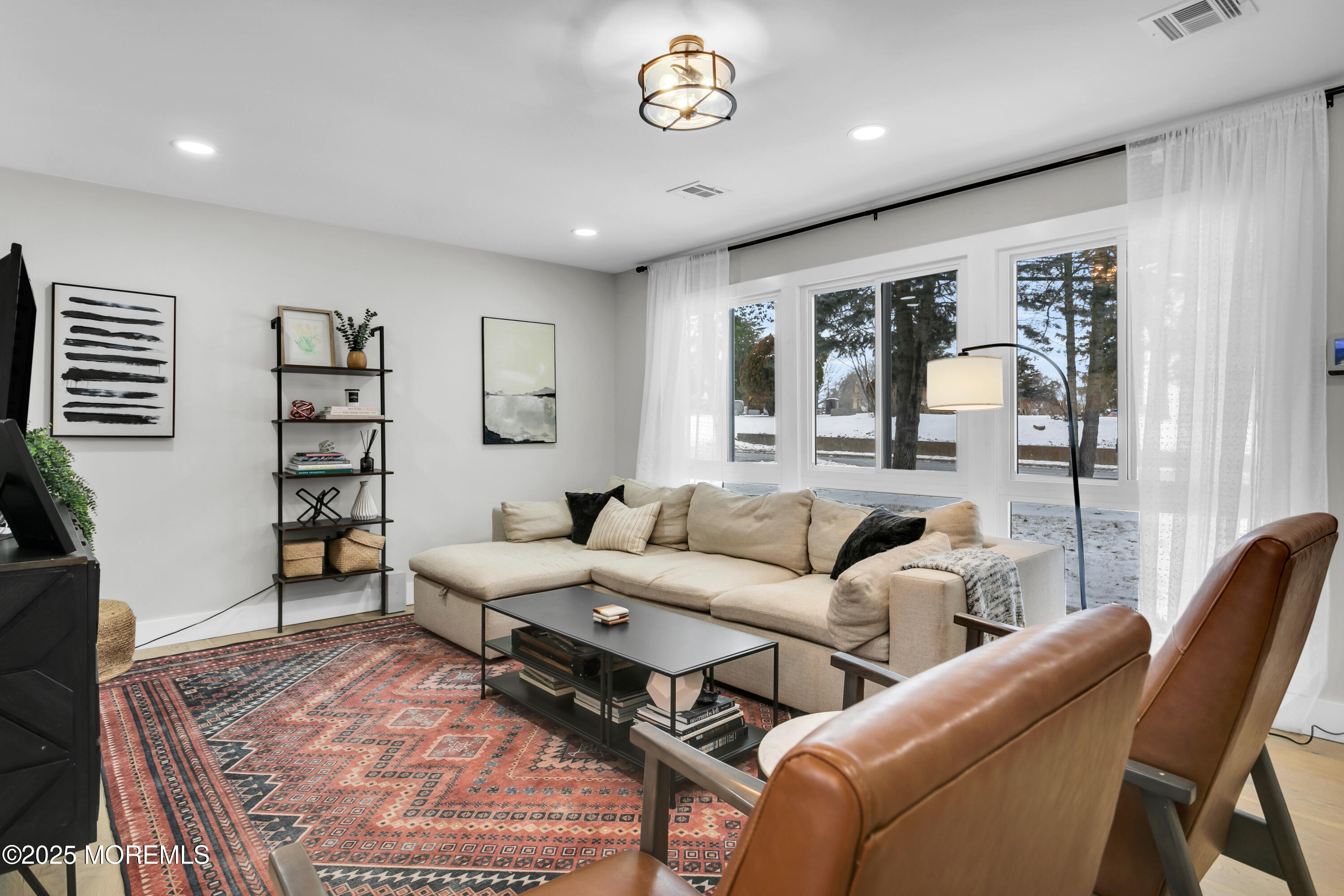 197 Oak Hill Road Red Bank, NJ 07701 - Photo 5 of 26 a living room with furniture a table and a flat screen tv