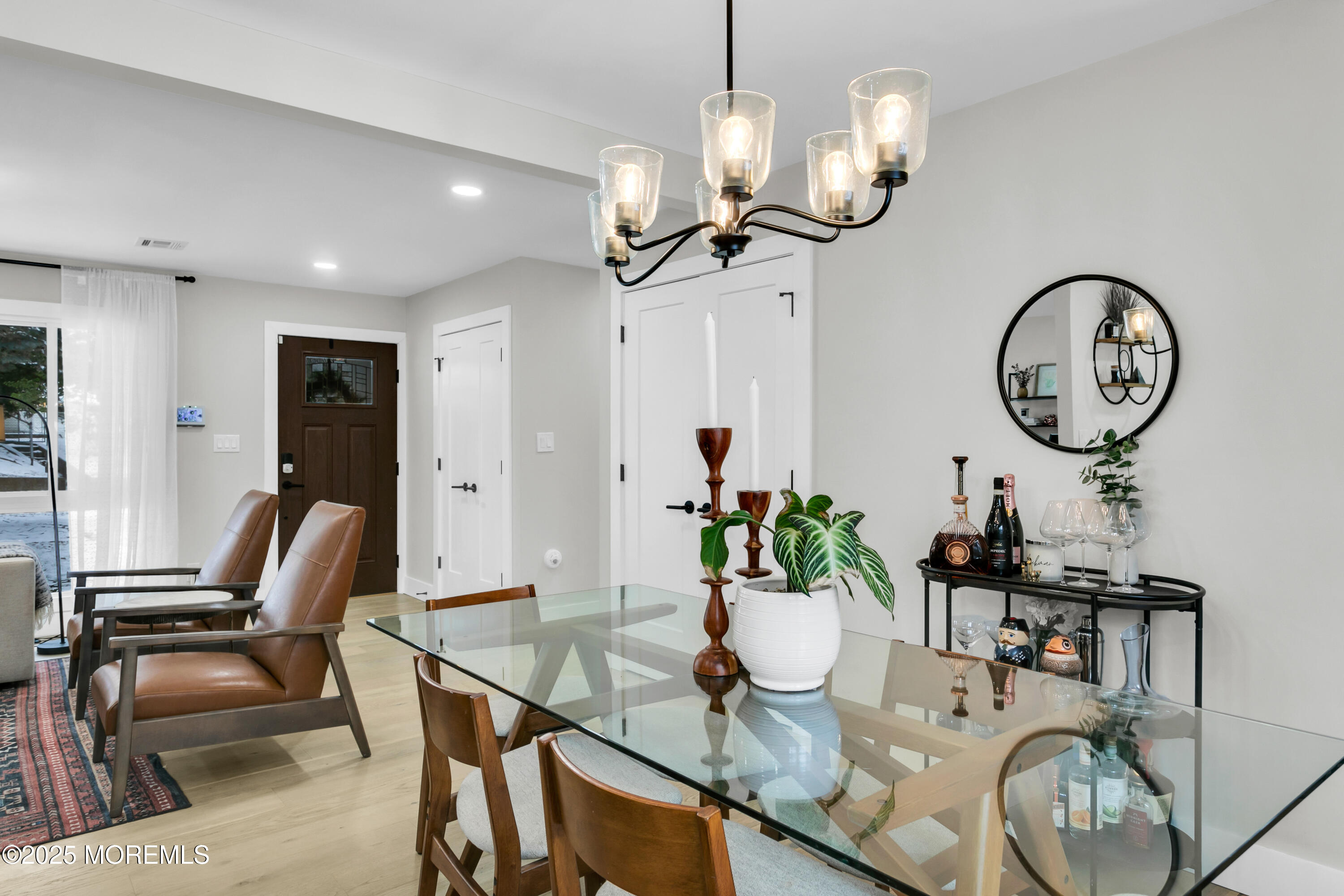 197 Oak Hill Road Red Bank, NJ 07701 - Photo 7 of 26 a view of a dining room with furniture a chandelier and wooden floor