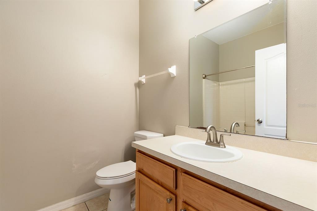 5255 Shale Ridge Trail Orlando, FL 32818 - Photo 21 of 24 a bathroom with a sink toilet and a mirror