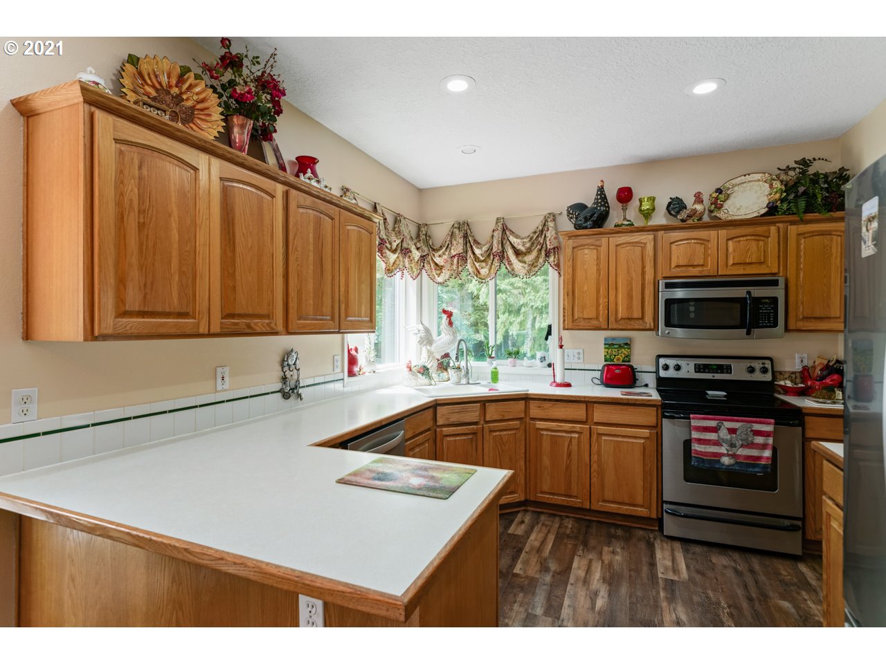 29000 Southeast Knox Road Boring, OR 97009 - Photo 16 of 30 a kitchen with kitchen island granite countertop a sink counter top space appliances and cabinets