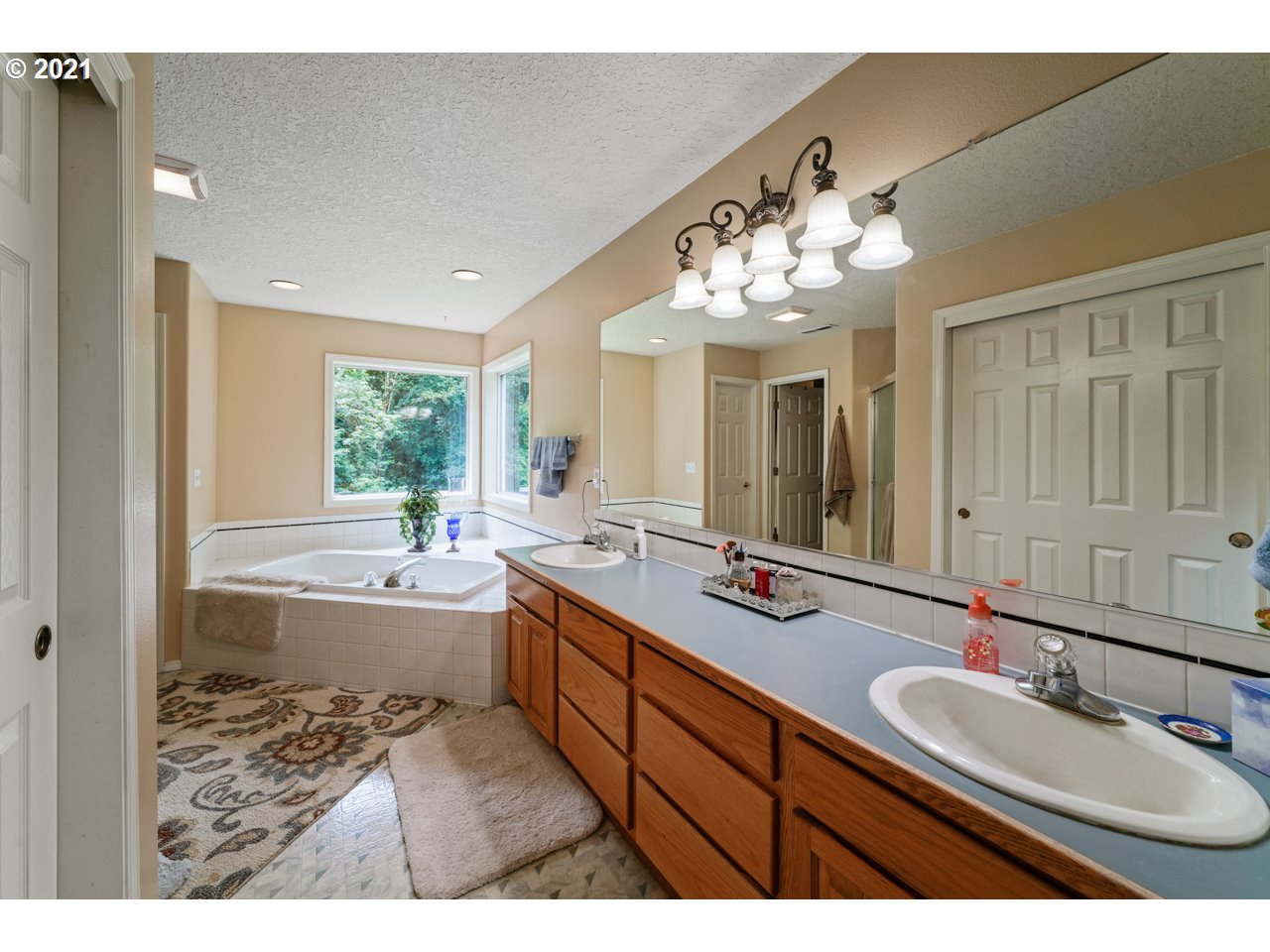 29000 Southeast Knox Road Boring, OR 97009 - Photo 26 of 30 a bathroom with a tub sink double vanity and mirror
