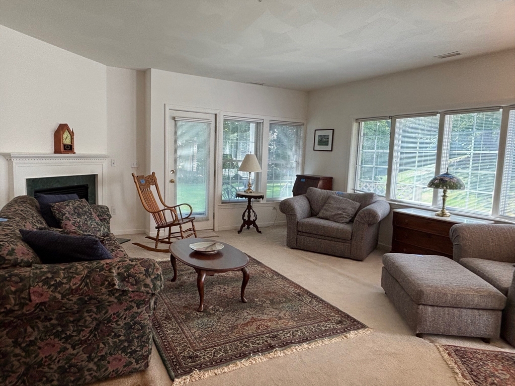 1 Riverview Boulevard, Unit 38 Methuen, MA 01844 - Photo 13 of 41 a living room with furniture and a fireplace