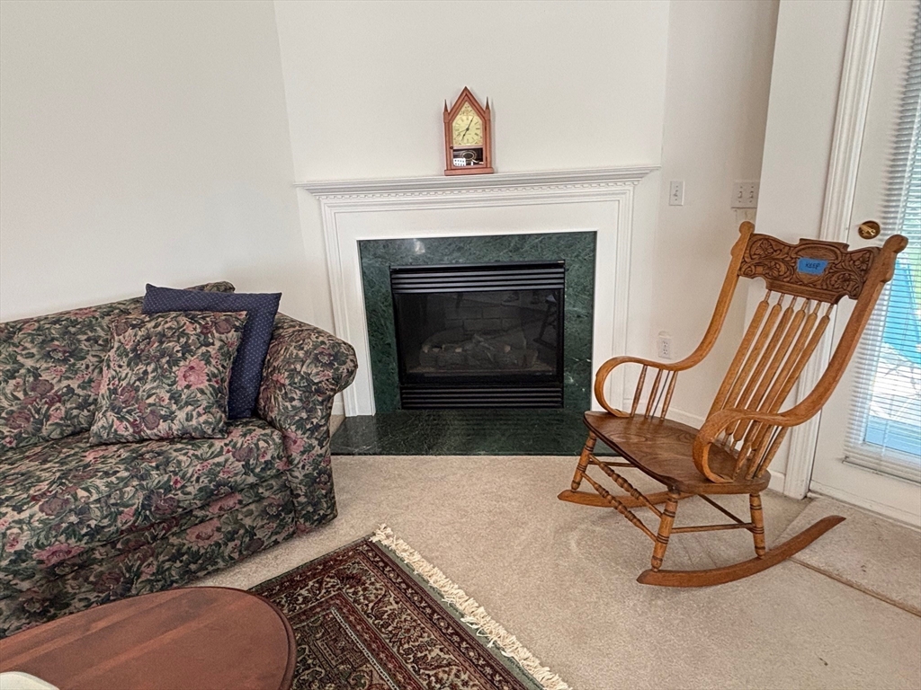 1 Riverview Boulevard, Unit 38 Methuen, MA 01844 - Photo 14 of 41 a living room with furniture and a fireplace
