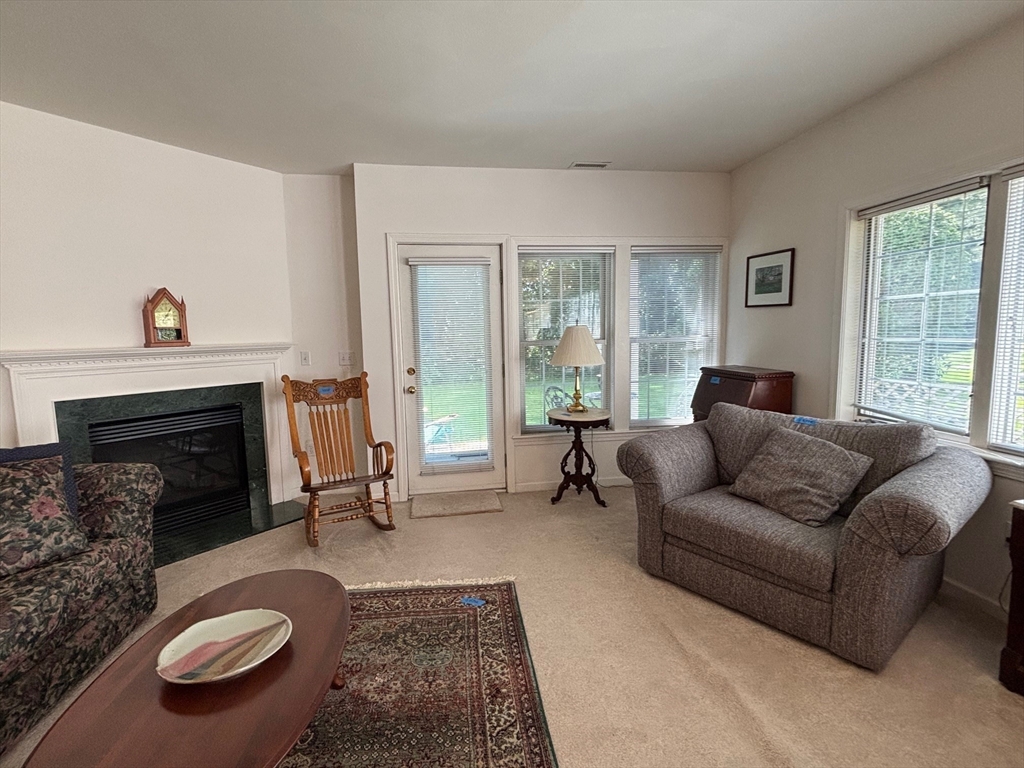 1 Riverview Boulevard, Unit 38 Methuen, MA 01844 - Photo 17 of 41 a living room with furniture a fireplace and a large window