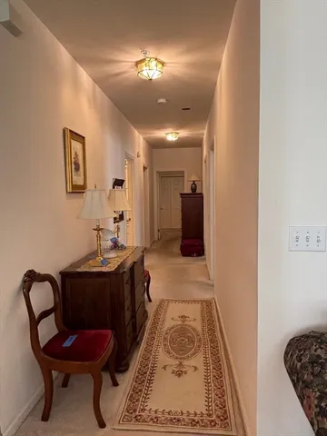 a living room with furniture rug and a large window