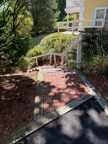 a view of a house with yard and sitting area