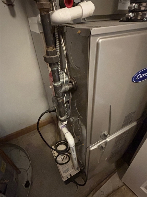 1 Riverview Boulevard, Unit 38 Methuen, MA 01844 - Photo 33 of 41 a room with water heater and wooden cabinets